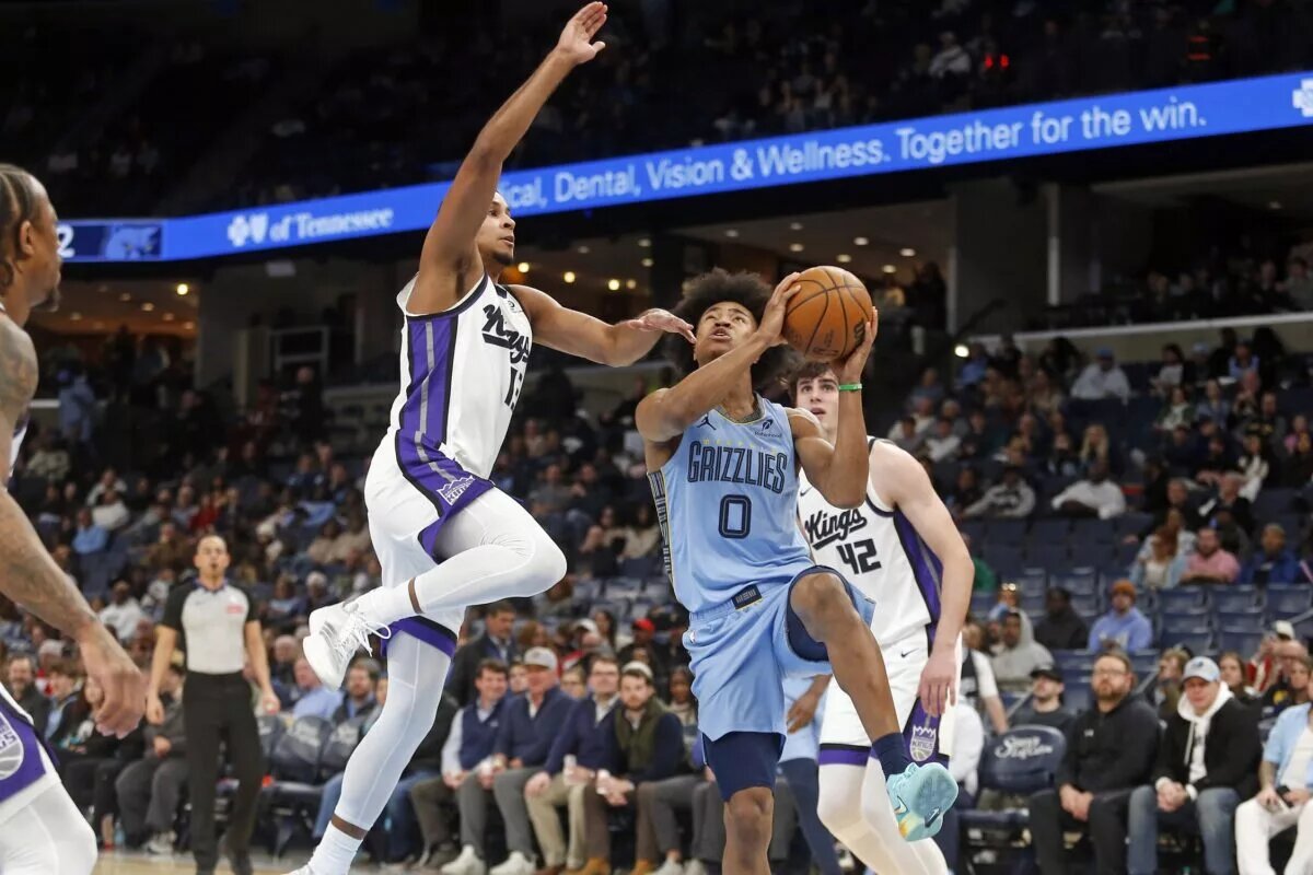 Feb 23, 2026; Memphis, Tennessee, USA; Memphis Grizzlies forward Jaylen Wells (0) shoots as Sacramento Kings forward Keegan Murray (13) defends during the third quarter at FedExForum. Mandatory Credit: Petre Thomas-Imagn Images