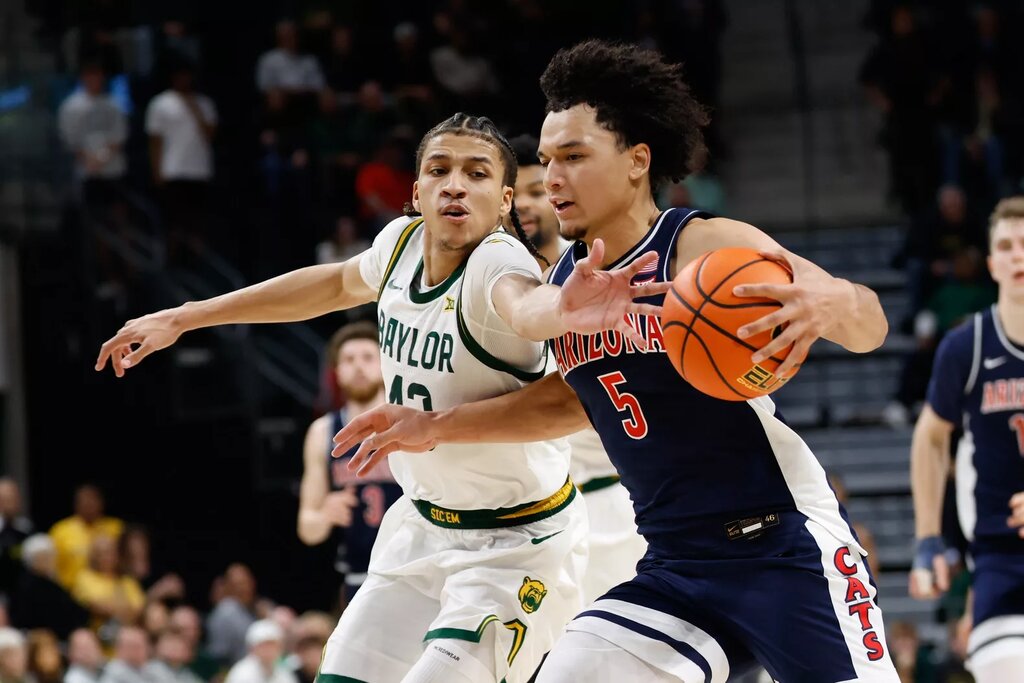 Arizona Wildcats guard Brayden Burries (5) is fouled by Baylor Bears guard Cameron Carr (43) during the second half at Paul and Alejandra Foster Pavilion.