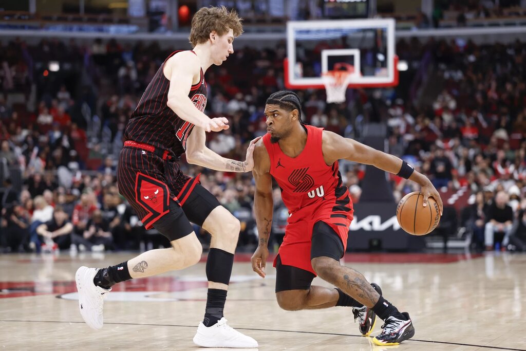 Portland Trail Blazers guard Scoot Henderson (00) is defended by Chicago Bulls forward Matas Buzelis (14) during the second half of an NBA game at United Center.