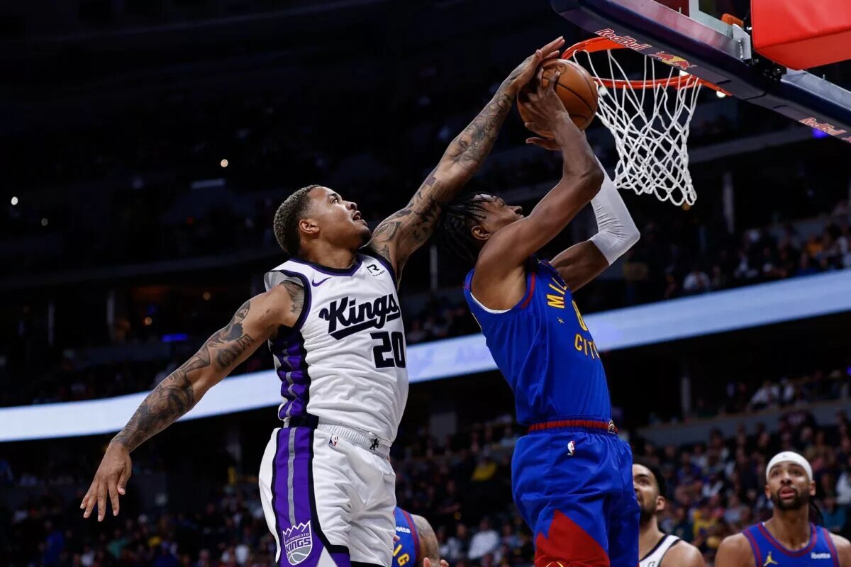 Mar 5, 2025; Denver, Colorado, USA; Sacramento Kings guard Markelle Fultz (20) blocks the shot attempt of Denver Nuggets forward Peyton Watson (8) in the first quarter at Ball Arena. Mandatory Credit: Isaiah J. Downing-Imagn Images