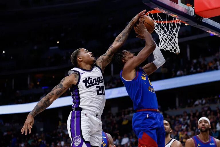 Mar 5, 2025; Denver, Colorado, USA; Sacramento Kings guard Markelle Fultz (20) blocks the shot attempt of Denver Nuggets forward Peyton Watson (8) in the first quarter at Ball Arena. Mandatory Credit: Isaiah J. Downing-Imagn Images