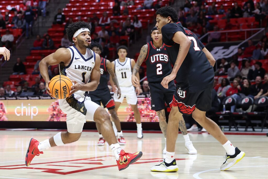 California Baptist Lancers guard Dominique Daniels Jr. (1) drives to the basket against Utah Utes forward Josh Hayes (7) during the first half at Jon M. Huntsman Center.