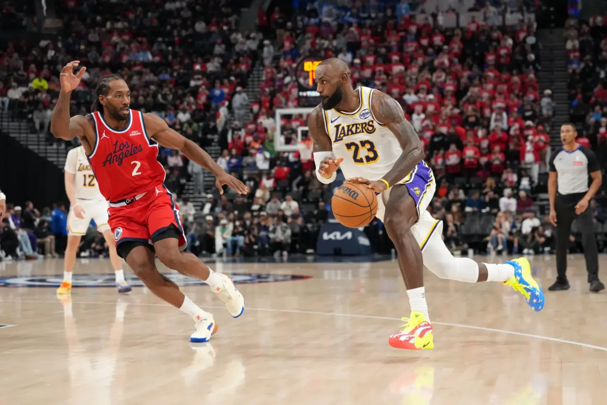 Los Angeles Lakers forward Lebron James (23) dribbles the ball against LA Clippers forward Kawhi Leonard (2) in the second half at Intuit Dome.
