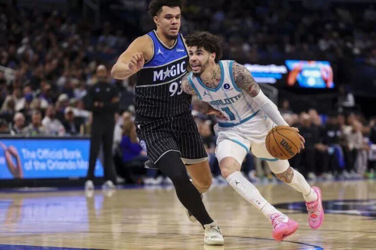 Jan 22, 2026; Orlando, Florida, USA; Charlotte Hornets guard LaMelo Ball (1) drives the ball past Orlando Magic forward Noah Penda (93) in the fourth quarter at Kia Center. Mandatory Credit: Nathan Ray Seebeck-Imagn Images