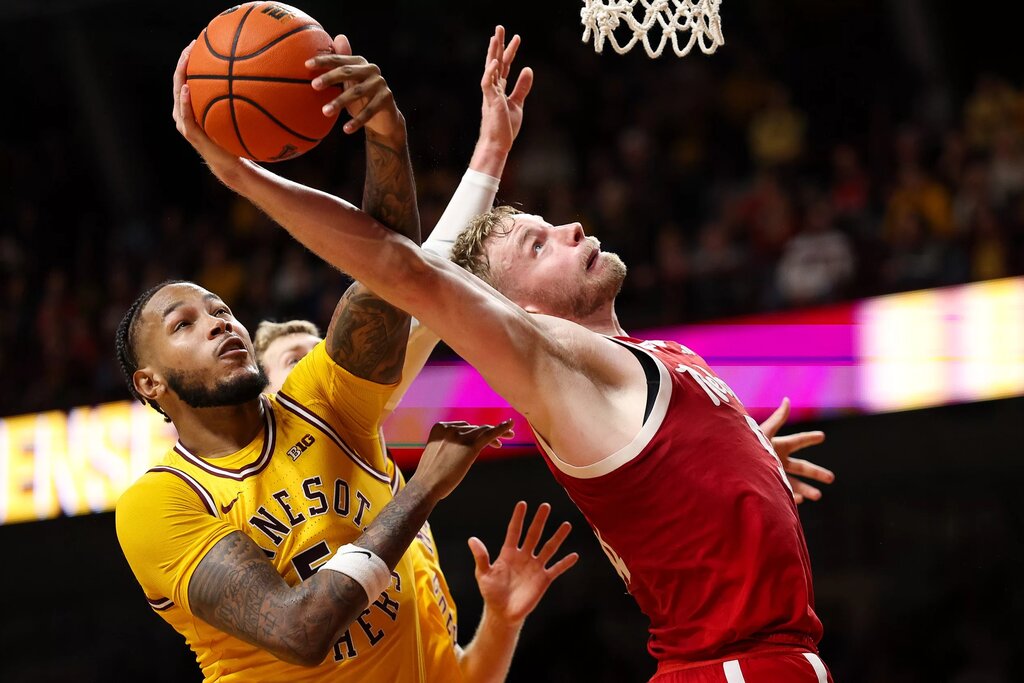 Jan 24, 2026; Minneapolis, Minnesota, USA; Nebraska Cornhuskers forward Rienk Mast (51) and Minnesota Golden Gophers forward Jaylen Crocker-Johnson (5) jump for a rebound during the second half at Williams Arena. Mandatory Credit: Matt Krohn-Imagn Images