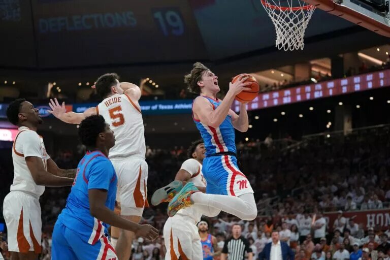 Feb 7, 2026; Austin, Texas, USA; Mississippi Rebels guard Eduardo Klafke (8) makes a lay up past Texas Longhorns forward Camden Heide (5) during the second half at Moody Center. Mandatory Credit: Dustin Safranek-Imagn Images