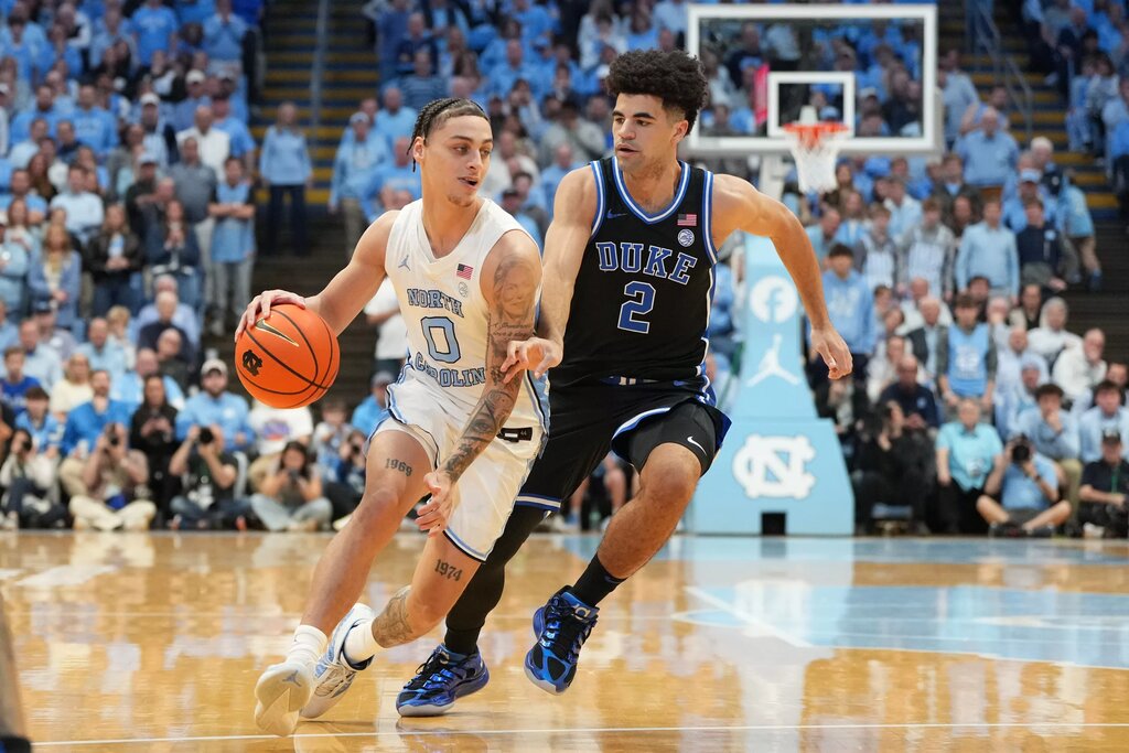 Feb 7, 2026; Chapel Hill, North Carolina, USA; North Carolina Tar Heels guard Kyan Evans (0) dribbles as Duke Blue Devils guard Cayden Boozer (2) defends in the second half at Dean E. Smith Center. Mandatory Credit: Bob Donnan-Imagn Images