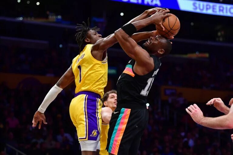 Feb 10, 2026; Los Angeles, California, USA; Los Angeles Lakers forward Adou Thiero (1) defends the basket against San Antonio Spurs center Bismack Biyombo (18) during the second half at Crypto.com Arena. Mandatory Credit: Gary A. Vasquez-Imagn Images