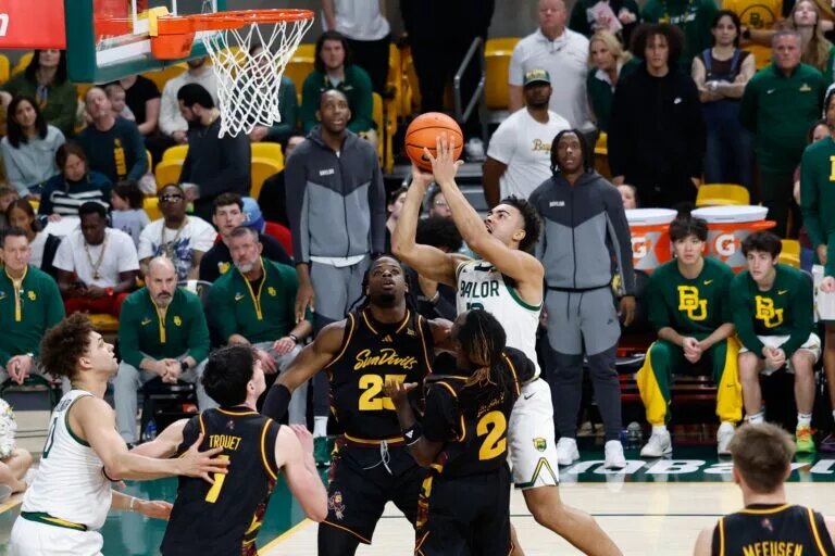 Feb 21, 2026; Waco, Texas, USA; Baylor Bears guard Isaac Williams (10) scores a basket over Arizona State Sun Devils guard Anthony Johnson (2) during the second half at Paul and Alejandra Foster Pavilion. Mandatory Credit: Chris Jones-Imagn Images