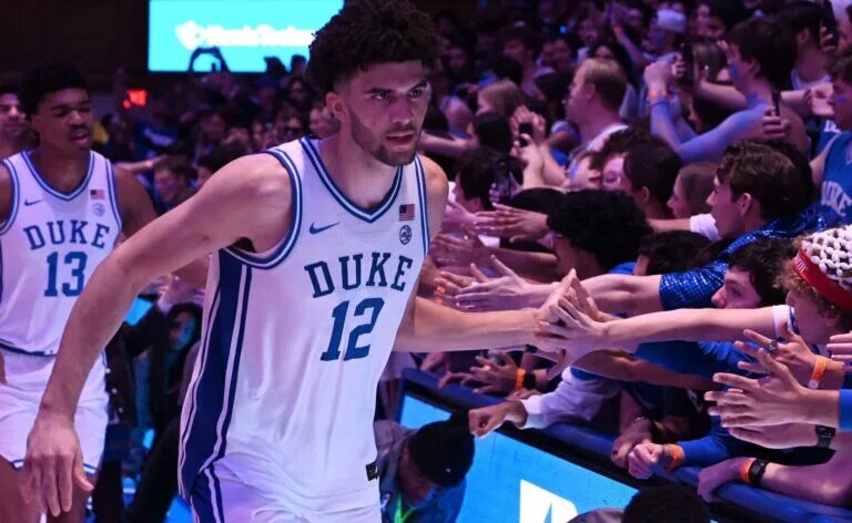 Duke Blue Devils forward Cameron Boozer (12) greets fans after a win over the Virginia Cavaliers at Cameron Indoor Stadium. Duke won 77-51.