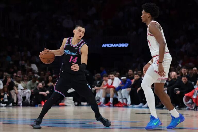 Feb 28, 2026; Miami, Florida, USA; Miami Heat guard Tyler Herro (14) dribbles the basketball against Houston Rockets guard Amen Thompson (1) during the third quarter at Kaseya Center. Mandatory Credit: Sam Navarro-Imagn Images