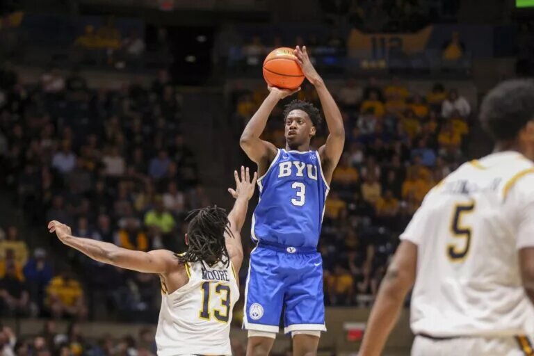 BYU Cougars forward AJ Dybantsa (3) shoots a three point shot over West Virginia Mountaineers guard Chance Moore (13) during the first half at Hope Coliseum.