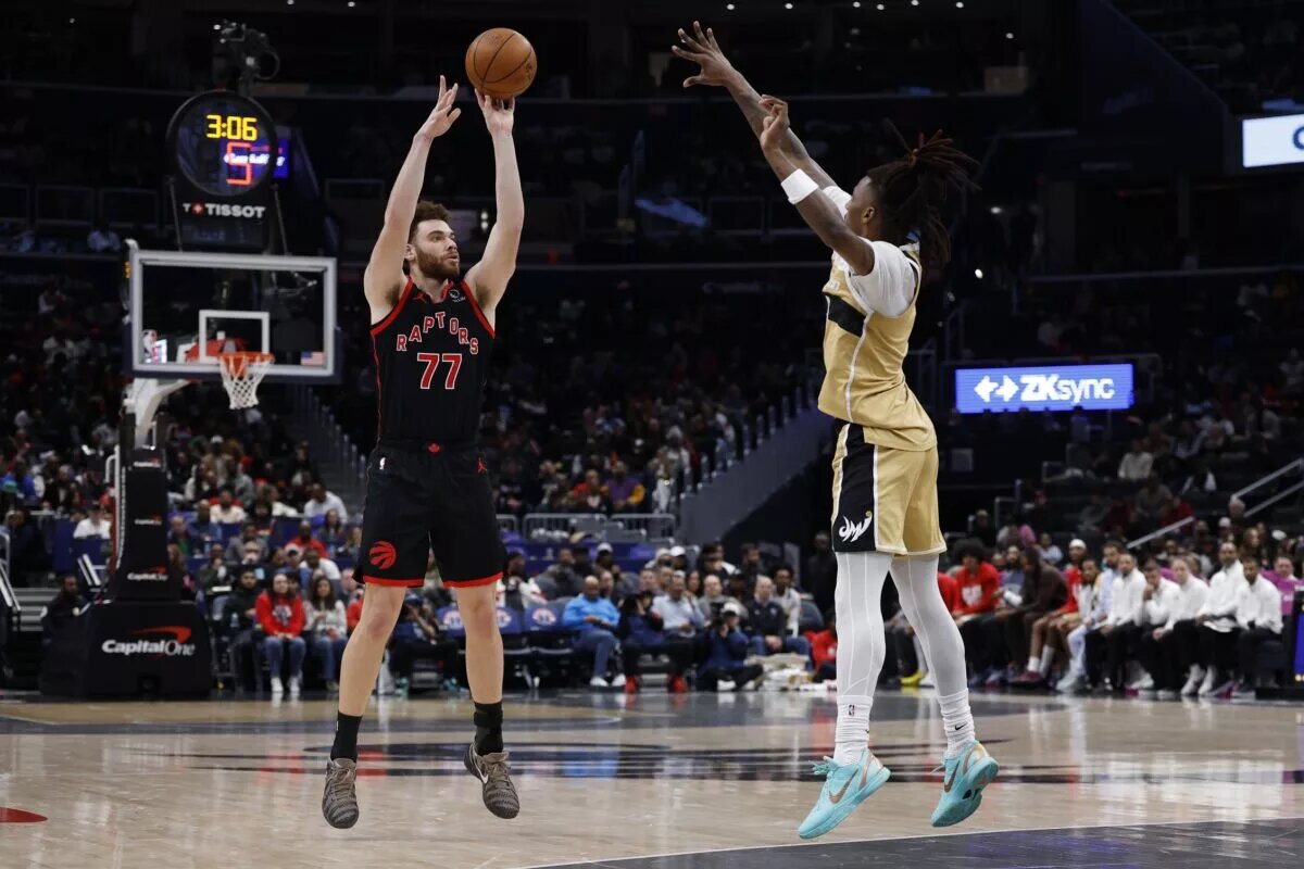 Toronto Raptors forward Jamison Battle (77) shoots the ball over Washington Wizards guard Jamir Watkins (5) in the second half at Capital One Arena.