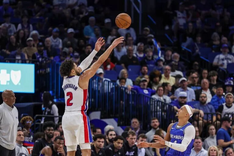 Mar 1, 2026; Orlando, Florida, USA; Detroit Pistons guard Cade Cunningham (2) shoots a three-point basket over Orlando Magic guard Jalen Suggs (4) during the second half at Kia Center. Mandatory Credit: Mike Watters-Imagn Images