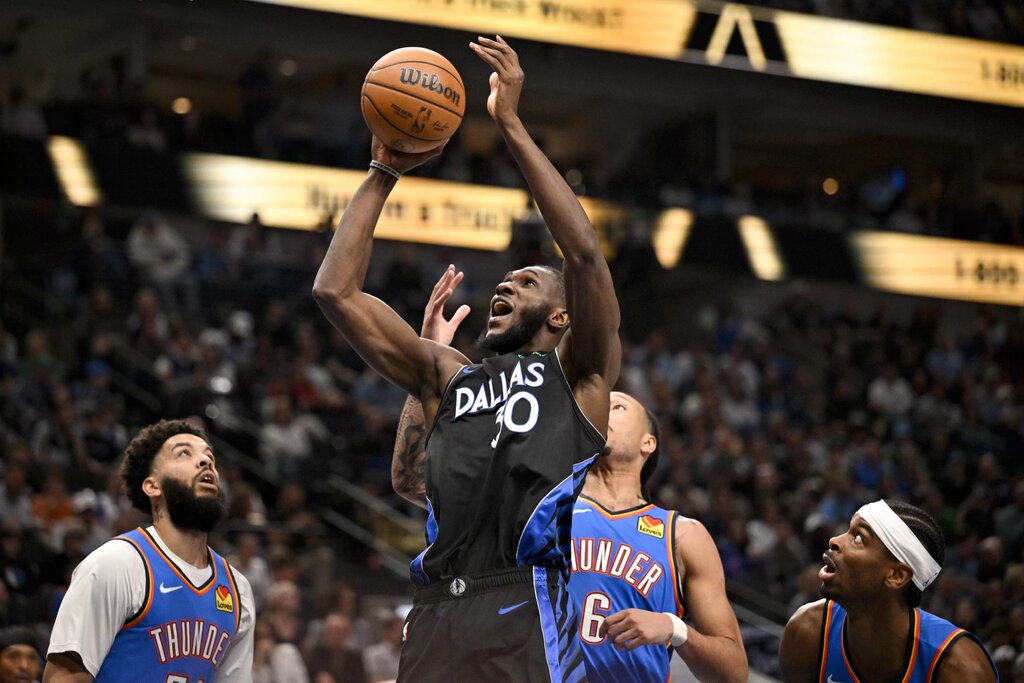 Mar 1, 2026; Dallas, Texas, USA; Dallas Mavericks center Moussa Cisse (30) grabs a rebound over Oklahoma City Thunder forward Jaylin Williams (6) during the second quarter at the American Airlines Center. Mandatory Credit: Jerome Miron-Imagn Images