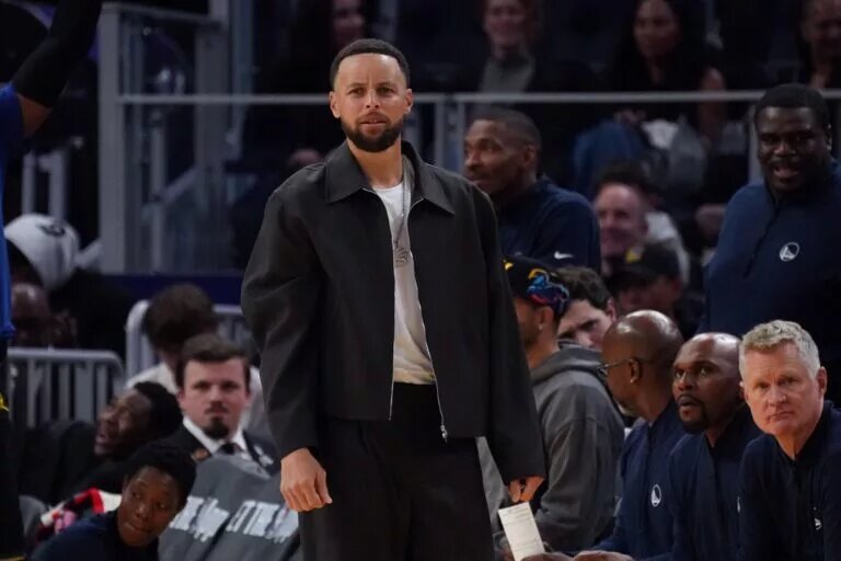 Feb 22, 2026; San Francisco, California, USA; Golden State Warriors guard Stephen Curry (30) watches from the bench in the third quarter during a game against the Denver Nuggets at Chase Center. Mandatory Credit: David Gonzales-Imagn Images