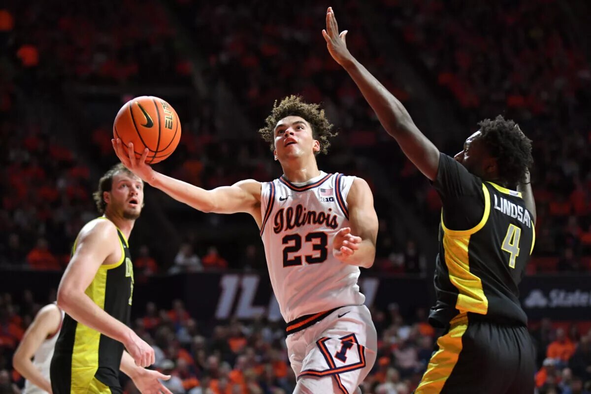 Keaton Wagler (No. 23) drives for a lay-up against Iowa