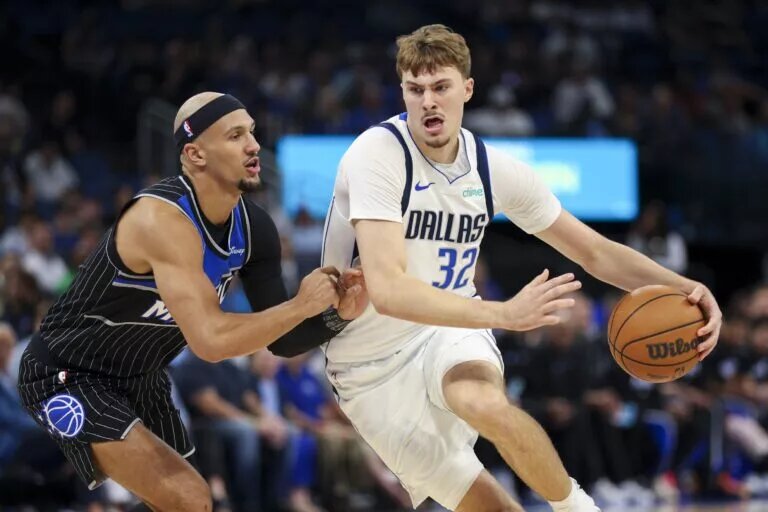 Mar 5, 2026; Orlando, Florida, USA; Dallas Mavericks forward Cooper Flagg (32) is guarded by Orlando Magic guard Jalen Suggs (4) in the first quarter at Kia Center. Mandatory Credit: Nathan Ray Seebeck-Imagn Images