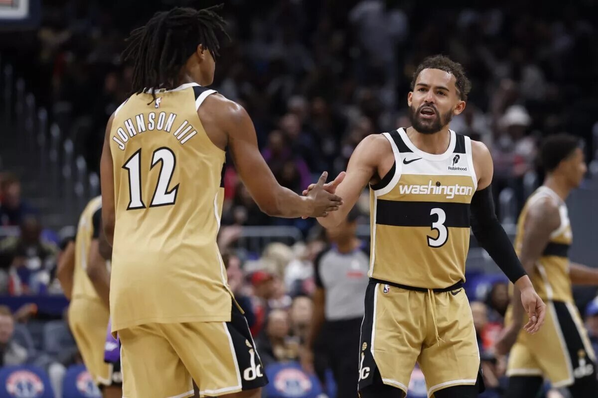 Mar 5, 2026; Washington, District of Columbia, USA; Washington Wizards guard Trae Young (3) celebrates with Wizards guard Tre Johnson (12) after a base against the Utah Jazz in the second half at Capital One Arena. Mandatory Credit: Geoff Burke-Imagn Images