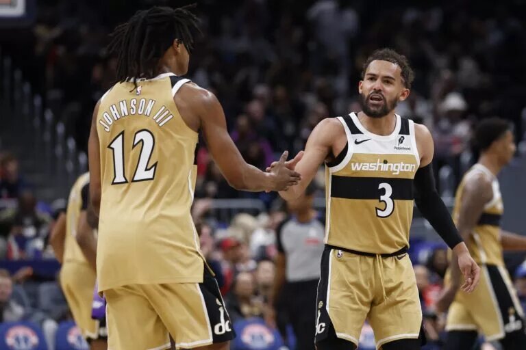 Mar 5, 2026; Washington, District of Columbia, USA; Washington Wizards guard Trae Young (3) celebrates with Wizards guard Tre Johnson (12) after a base against the Utah Jazz in the second half at Capital One Arena. Mandatory Credit: Geoff Burke-Imagn Images