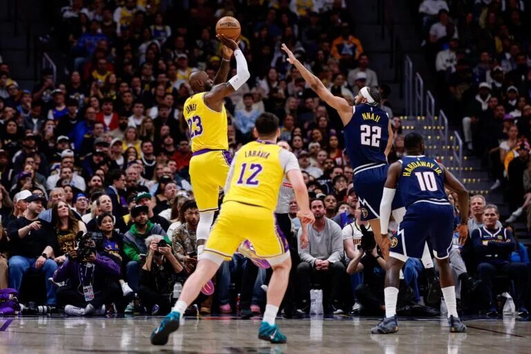 Mar 5, 2026; Denver, Colorado, USA; Los Angeles Lakers forward LeBron James (23) scores a basket over Denver Nuggets forward Zeke Nnaji (22) to break the NBA regular season field goals made record as forward Jake LaRavia (12) and guard Tim Hardaway Jr. (10) defend in the first quarter at Ball Arena. The record was held by Kareem Abdul-Jabbar with 15,835 made field goals. Mandatory Credit: Isaiah J. Downing-Imagn Images