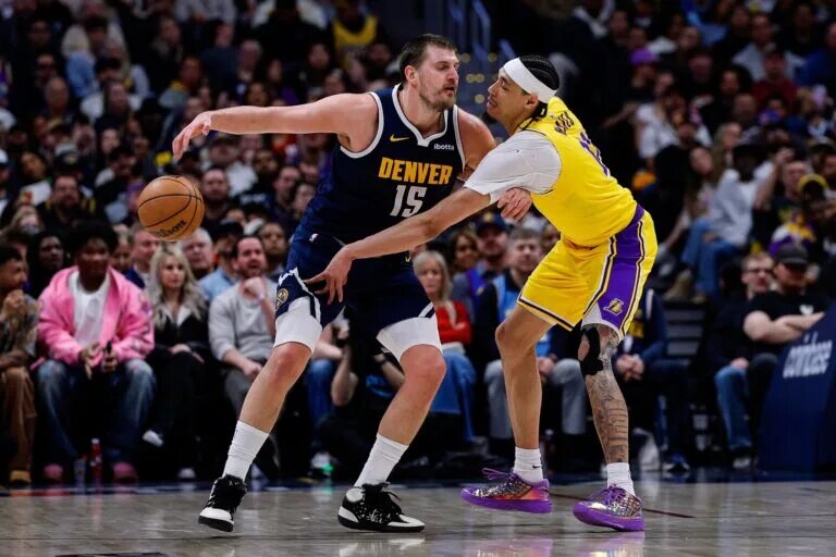 Mar 5, 2026; Denver, Colorado, USA; Los Angeles Lakers center Jaxson Hayes (11) knocks the ball away from Denver Nuggets center Nikola Jokic (15) in the fourth quarter at Ball Arena. Mandatory Credit: Isaiah J. Downing-Imagn Images