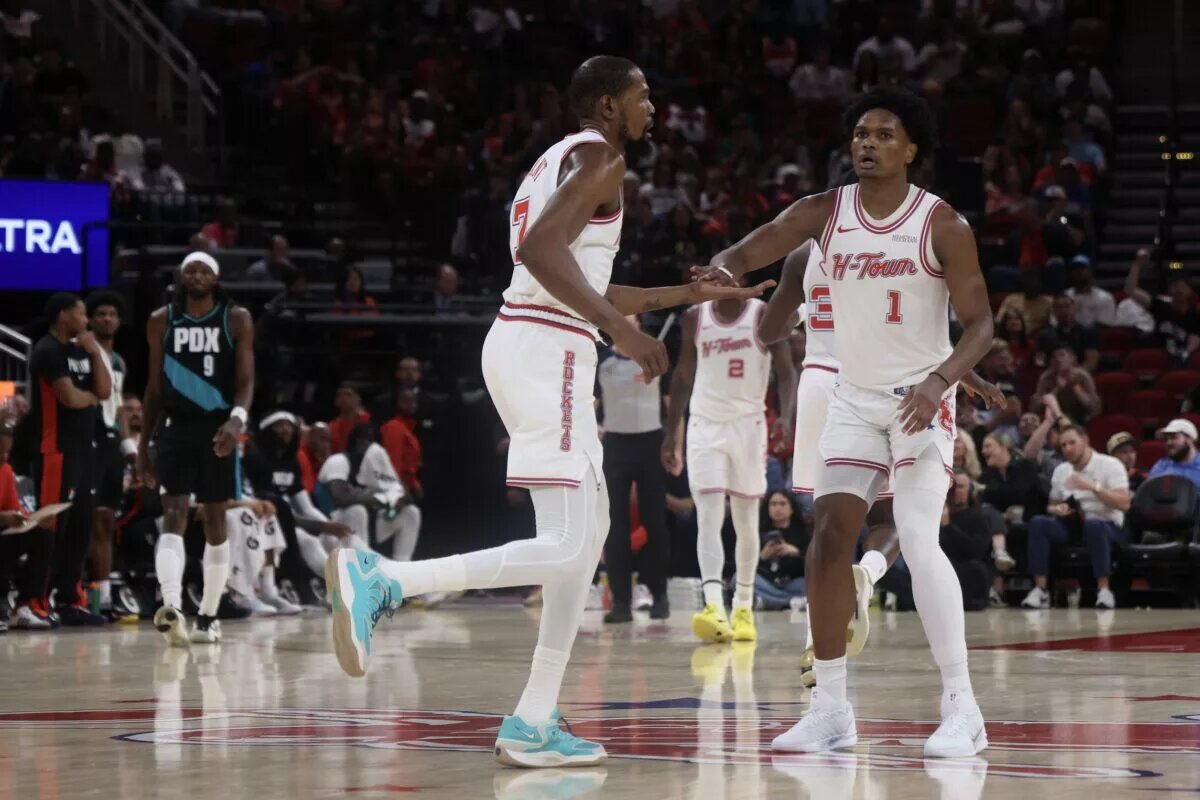 Houston Rockets forwards Amen Thompson and Kevin Durant congratulate each other after a play