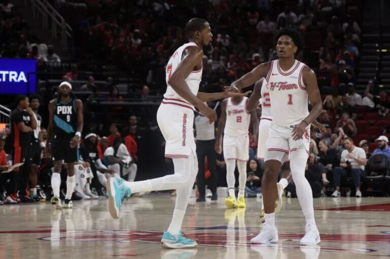 Houston Rockets forwards Amen Thompson and Kevin Durant congratulate each other after a play