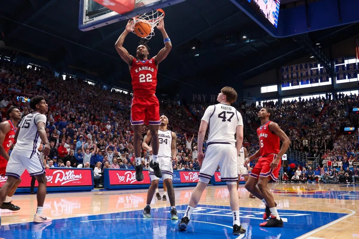 Mar 7, 2026; Lawrence, Kansas, USA; Kansas Jayhawks guard Darryn Peterson (22) dunks against Kansas State Wildcats forward Andrej Kostic (47) during the second half at Allen Fieldhouse. Mandatory Credit: Scott Sewell-Imagn Images