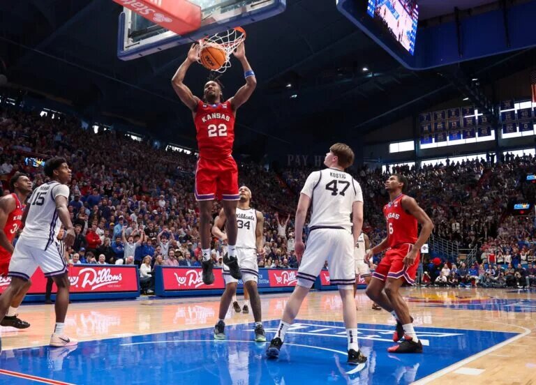 Mar 7, 2026; Lawrence, Kansas, USA; Kansas Jayhawks guard Darryn Peterson (22) dunks against Kansas State Wildcats forward Andrej Kostic (47) during the second half at Allen Fieldhouse. Mandatory Credit: Scott Sewell-Imagn Images