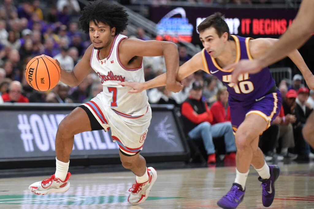 Mar 7, 2026; St. Louis, MO, USA; Bradley Braves guard Montana Wheeler (7) drives the ball past Northern Iowa Panthers guard RJ Taylor (10) during the first half at Enterprise Center. Mandatory Credit: Ron Johnson-Imagn Images