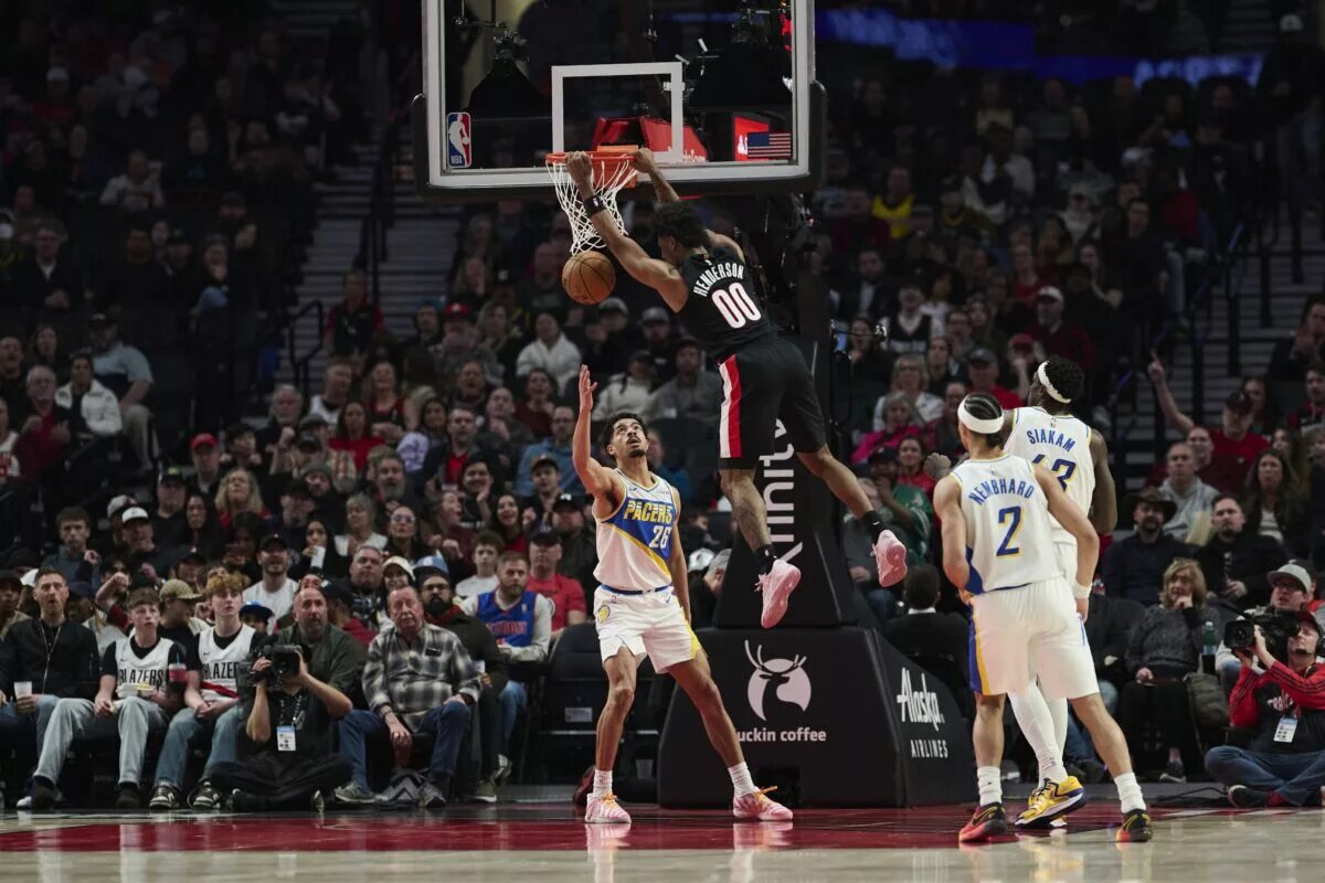 Mar 8, 2026; Portland, Oregon, USA; Portland Trail Blazers guard Scoot Henderson (00) dunks the basketball during the first half against Indiana Pacers guard Ben Sheppard (26) at Moda Center. Mandatory Credit: Troy Wayrynen-Imagn Images