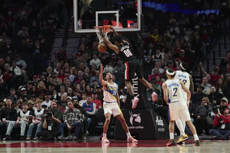 Mar 8, 2026; Portland, Oregon, USA; Portland Trail Blazers guard Scoot Henderson (00) dunks the basketball during the first half against Indiana Pacers guard Ben Sheppard (26) at Moda Center. Mandatory Credit: Troy Wayrynen-Imagn Images