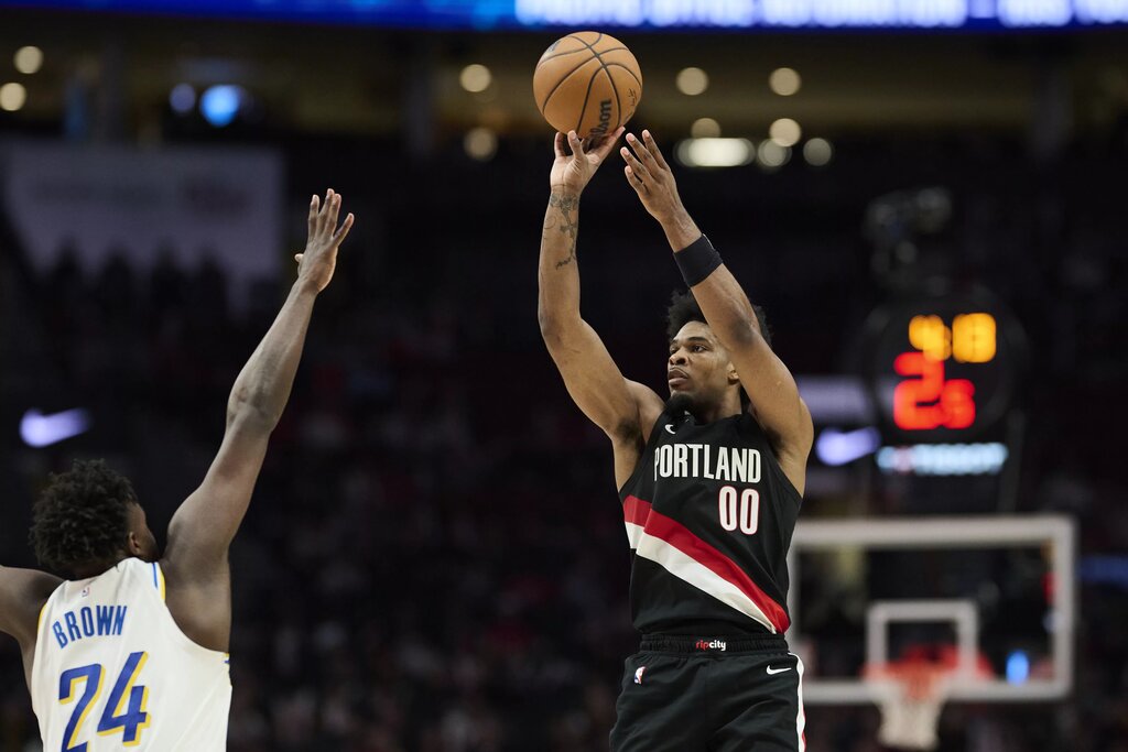 Mar 8, 2026; Portland, Oregon, USA; Portland Trail Blazers guard Scoot Henderson (00) shoots a jump shot during the second half against Indiana Pacers guard Kobe Brown (24) at Moda Center. Mandatory Credit: Troy Wayrynen-Imagn Images