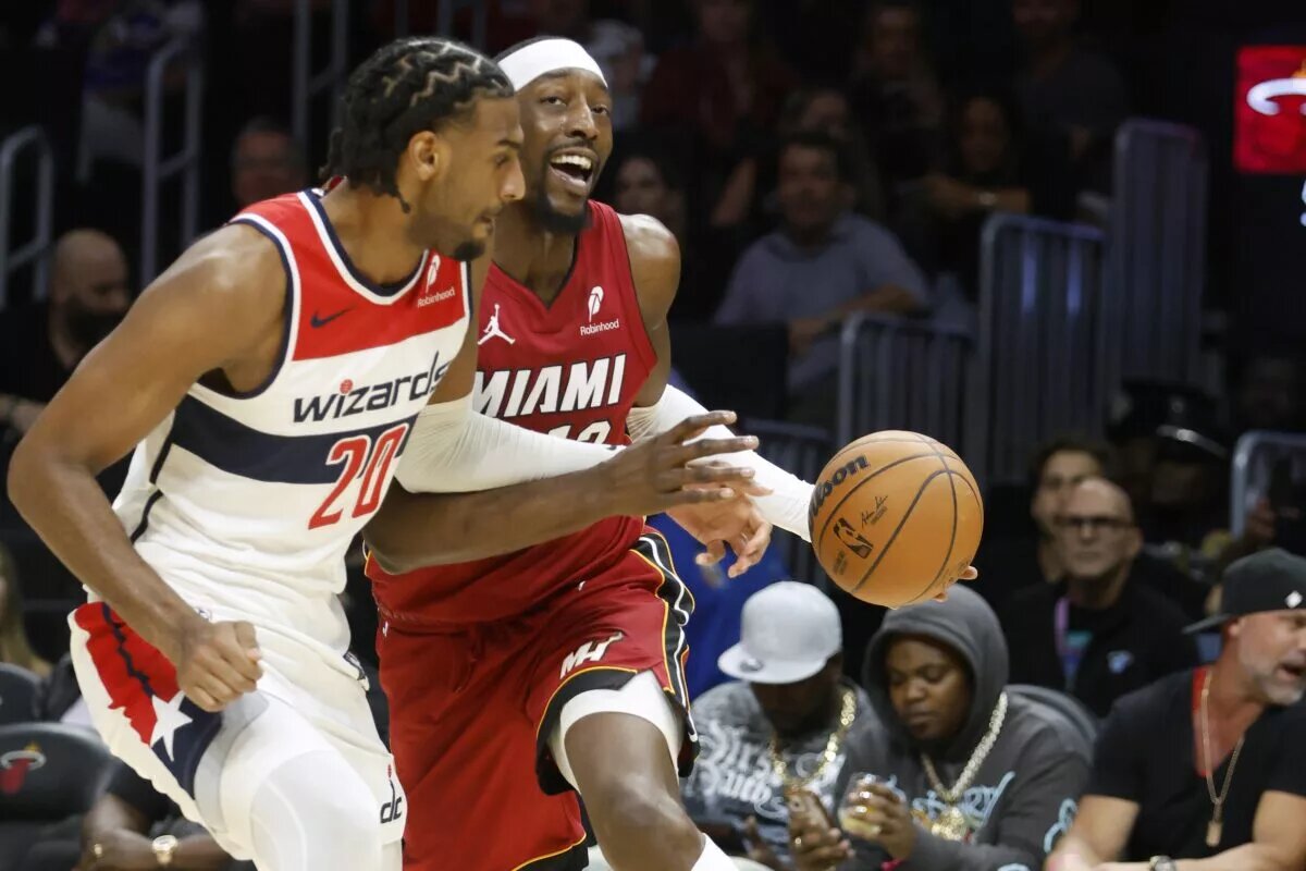 Washington Wizards center Alex Sarr (20) defends Miami Heat center Bam Adebayo (13) during the first half at Kaseya Center.