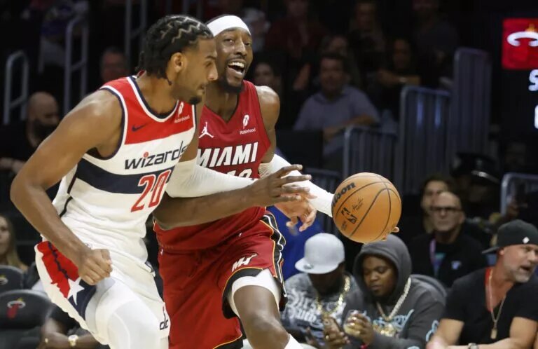 Washington Wizards center Alex Sarr (20) defends Miami Heat center Bam Adebayo (13) during the first half at Kaseya Center.