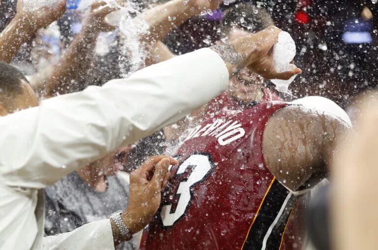Miami Heat center Bam Adebayo (13) celebrates with teammates after becoming the NBA's second highest scorer of points, with 83 in a game against the Washington Wizards