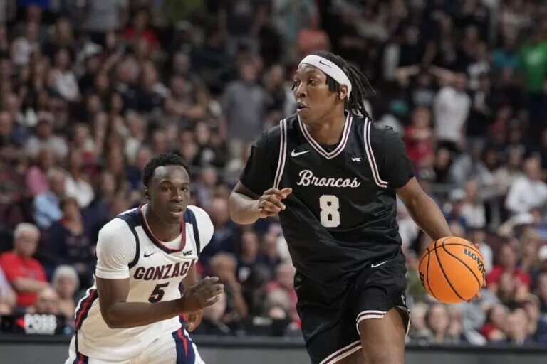 March 10, 2026; Las Vegas, NV, USA; Santa Clara Broncos forward Elijah Mahi (8) dribbles the basketball against Gonzaga Bulldogs forward Emmanuel Innocenti (5) during the second half at Orleans Arena. Mandatory Credit: Kyle Terada-Imagn Images