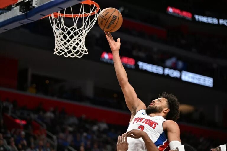 Mar 12, 2026; Detroit, Michigan, USA; Detroit Pistons guard Cade Cunningham (2) puts in a layup against the Philadelphia 76ers in the first half at Little Caesars Arena. Mandatory Credit: Lon Horwedel-Imagn Images