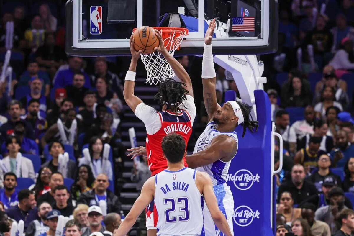 Mar 12, 2026; Orlando, Florida, USA; Washington Wizards guard Bilal Coulibaly (0) goes to the basket against Orlando Magic center Wendell Carter Jr. (34) during the second half at Kia Center. Mandatory Credit: Mike Watters-Imagn Images