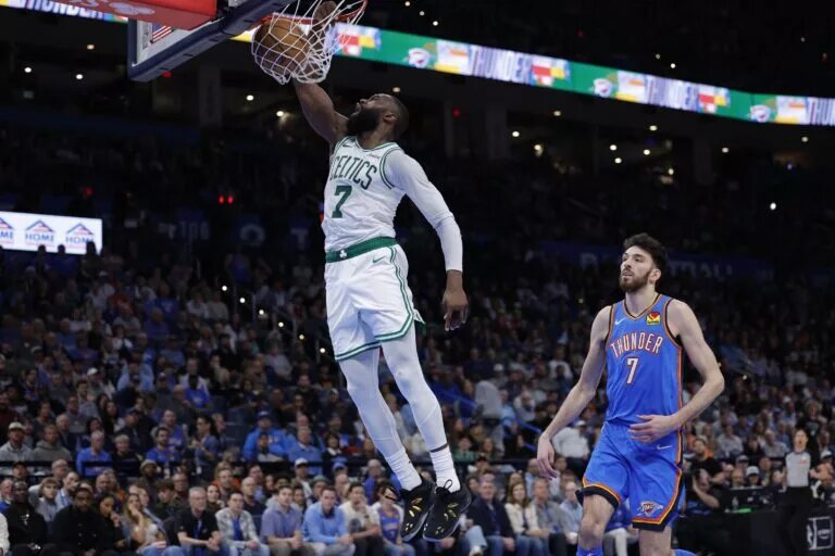Mar 12, 2026; Oklahoma City, Oklahoma, USA; Boston Celtics guard/forward Jaylen Brown (7) goes up for a dunk in front of Oklahoma City Thunder center/forward Chet Holmgren (7) during the fourth quarter at Paycom Center. Mandatory Credit: Alonzo Adams-Imagn Images