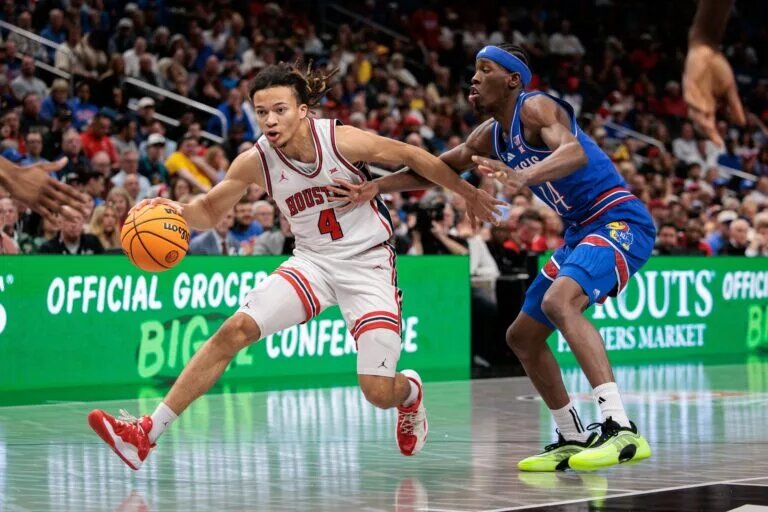 Mar 13, 2026; Kansas City, MO, USA; Houston Cougars guard Kingston Flemings (4) drives to the basket around Kansas Jayhawks guard Melvin Council Jr. (14) during the first half at T-Mobile Center. Mandatory Credit: William Purnell-Imagn Images