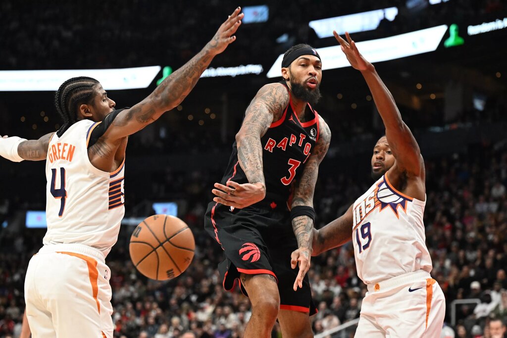 Toronto Raptors forward Brandon Ingram (3) passes the ball away from Phoenix Suns guard Jalen Green (4) and forward Haywood Highsmith (19) in the second half at Scotiabank Arena.