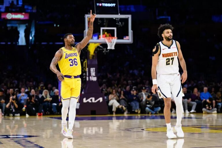 Mar 14, 2026; Los Angeles, California, USA; Los Angeles Lakers guard Marcus Smart (36) gestures after scoring over Denver Nuggets guard Jamal Murray (27) during the first half at Crypto.com Arena. Mandatory Credit: William Liang-Imagn Images