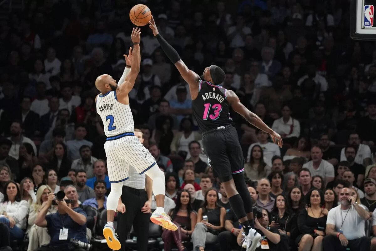 Mar 14, 2026; Miami, Florida, USA; Miami Heat center Bam Adebayo (13) blocks the shot of Orlando Magic guard Jevon Carter (2) during the second half at Kaseya Center. Mandatory Credit: Jim Rassol-Imagn Images