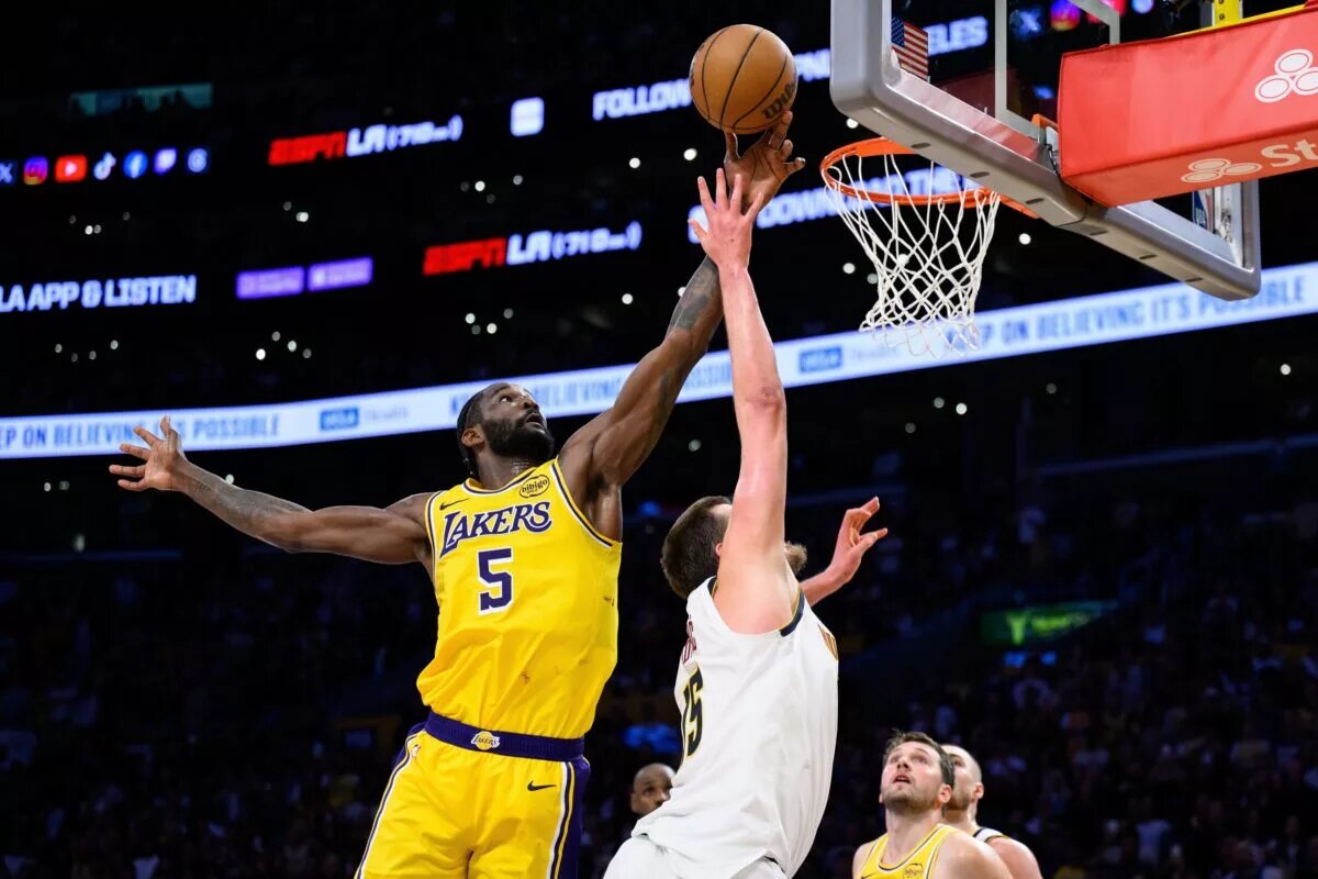 Mar 14, 2026; Los Angeles, California, USA; Los Angeles Lakers center Deandre Ayton (5) blocks a shot from Denver Nuggets center Nikola Jokic (15) during overtime at Crypto.com Arena. Mandatory Credit: William Liang-Imagn Images