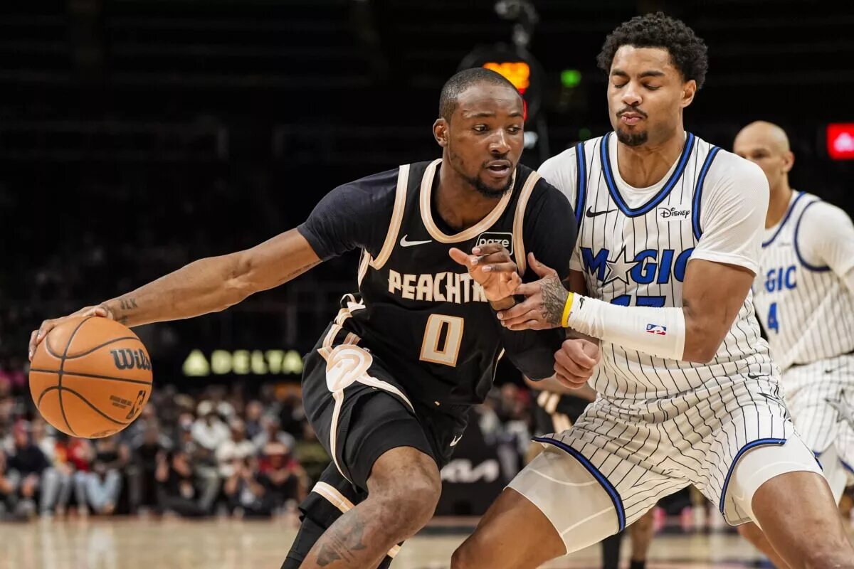 Atlanta Hawks forward Jonathan Kuminga (0) dribbles against Orlando Magic guard Jett Howard (13) during the second half at State Farm Arena.