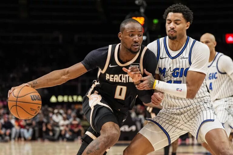 Atlanta Hawks forward Jonathan Kuminga (0) dribbles against Orlando Magic guard Jett Howard (13) during the second half at State Farm Arena.