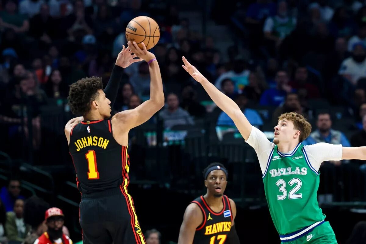 Atlanta Hawks forward Jalen Johnson (1) shoots over Dallas Mavericks forward Cooper Flagg (32) during the first quarter at American Airlines Center.