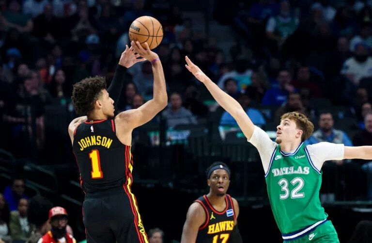 Atlanta Hawks forward Jalen Johnson (1) shoots over Dallas Mavericks forward Cooper Flagg (32) during the first quarter at American Airlines Center.